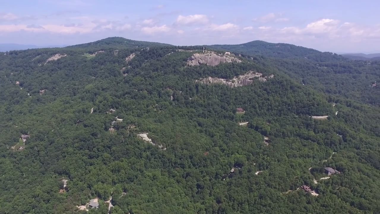 A wooded mountain ridge stretching into the distance